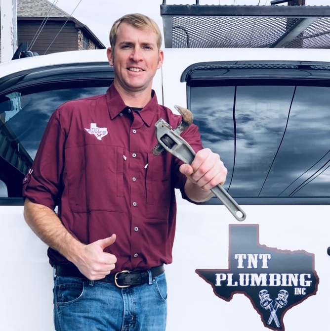 Bryce, owner of TNT Plumbing Services, standing next to a branded service truck