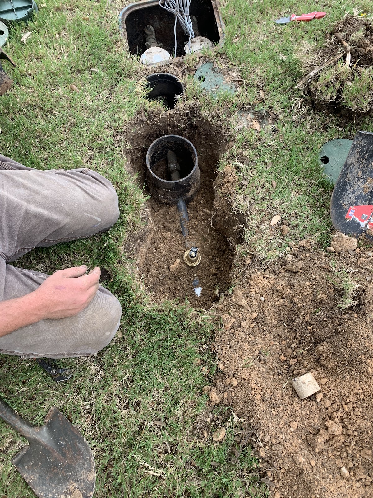 Underground irrigation and water line repair showing pipe connection in the ground