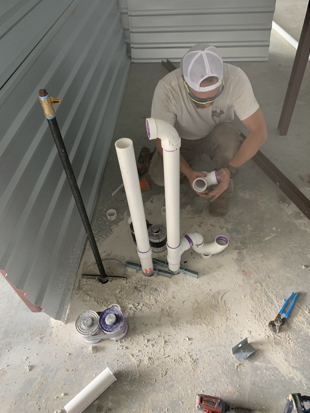 Plumber fitting PVC drain pipes for rough-in plumbing